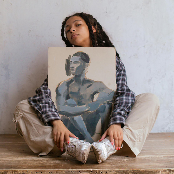 young-woman-holding-painting